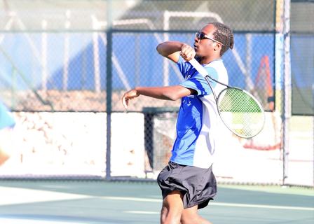 A CFHS tennis player returns a serve