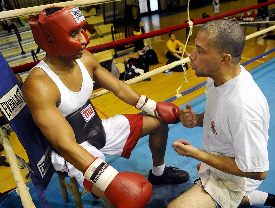 VIRGINIA BEACH, Va. (Oct. 12, 2008) Dave Cruz, right, an assistant coach with 757 Boxing Club in Virginia Beach, Va., gives his fighter pointers between rounds