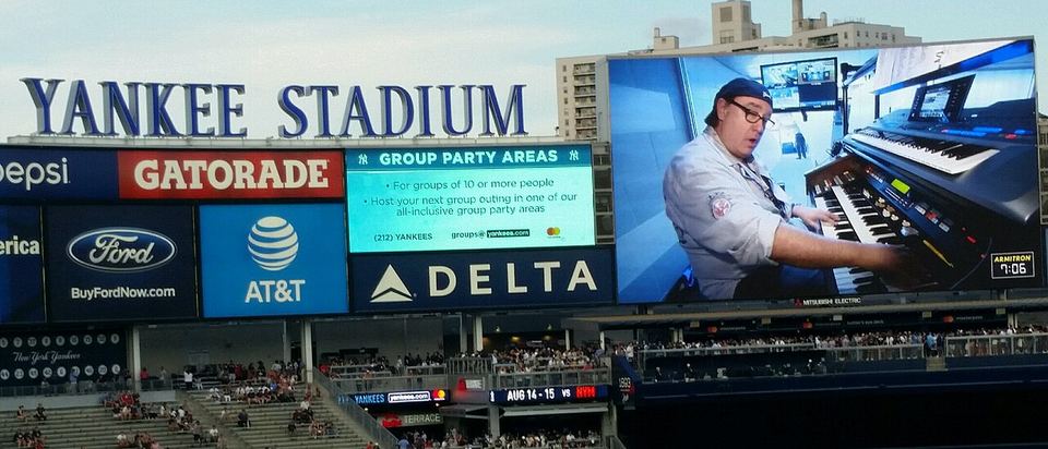 Ed Alstrom playing organ on the Yankee Stadium Scoreboard during a pre-game set