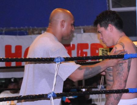 A referee checks Spc. Thomas Shield's gear during the amateur mixed martial arts fighting event, October 3