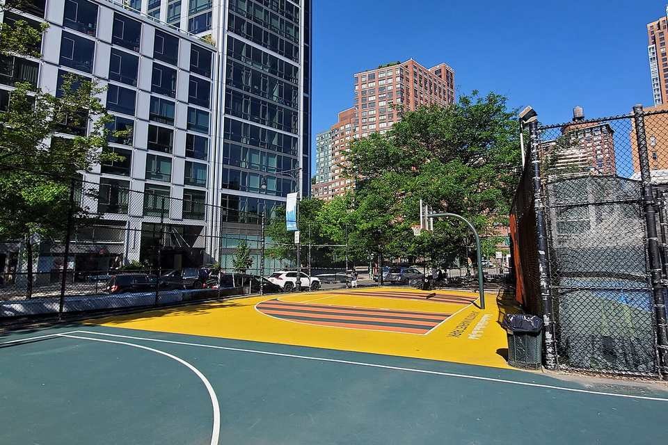 The repainted half court of the basketball courts at the west end of Washington Market Park, in front of BMCC at the northeast corner of Chambers Street and Wes