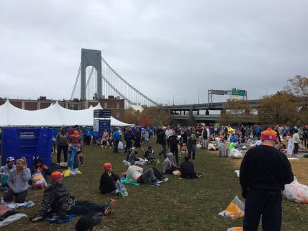 Runners wait at the start village of the New New York City Marathon, 2017