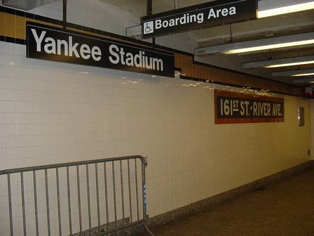 View of station identification signage from the en:161st Street – Yankee Stadium (IND Concourse Line) station northbound platform. On the right is the (restored
