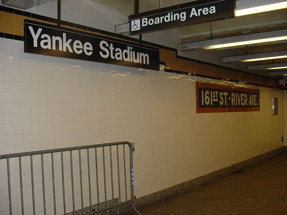 View of station identification signage from the en:161st Street – Yankee Stadium (IND Concourse Line) station northbound platform. On the right is the (restored