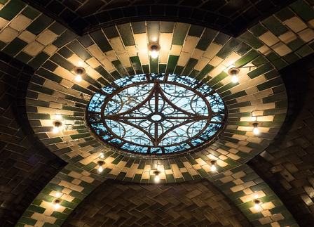 The defunct City Hall subway station in New York City, closed since 1945. The station has several skylights. Most of them are built into the arches above the pl