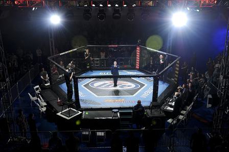 Staff Sgt. Zachery Rayburn, 460th Space Communications Squadron radio frequency system crew member, sings the national anthem during the Buckley MMA Fight Night